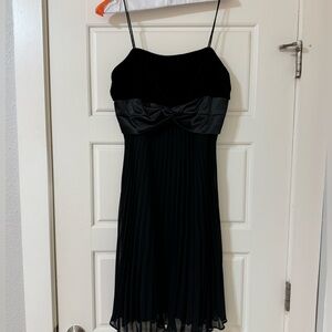 Black Cocktail Dress with Suede Top, Silk bow, and pleated skirt